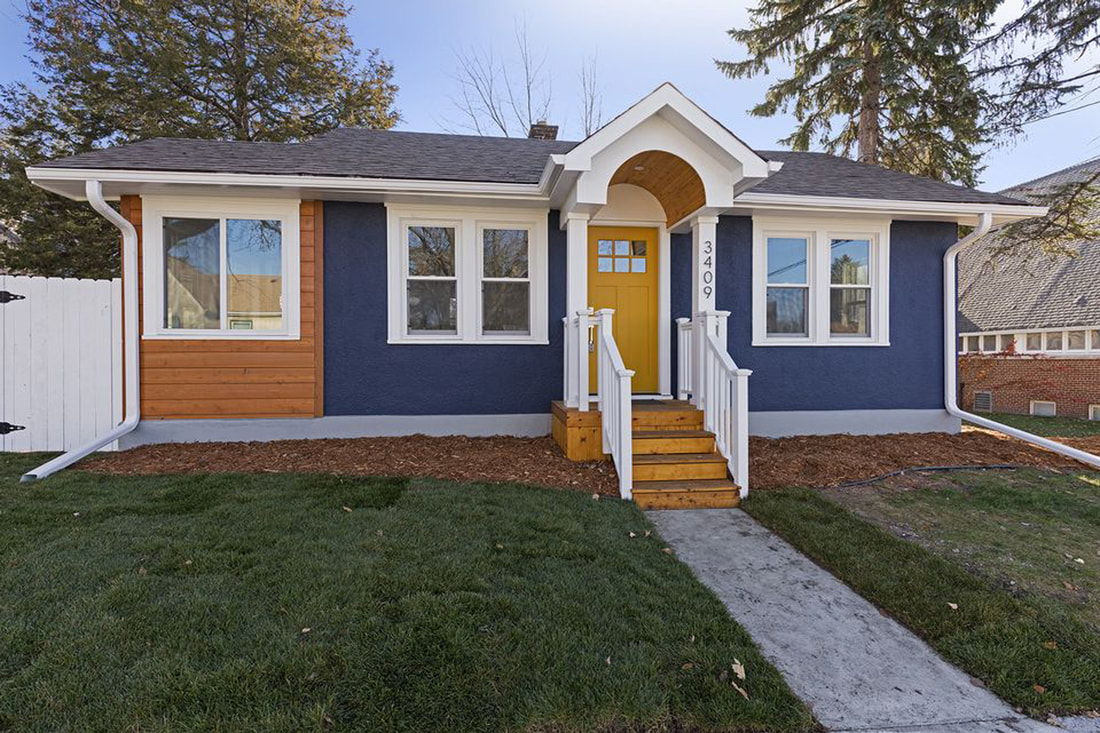 Completed Edina renovation with blue siding, wood accents, and a yellow front door